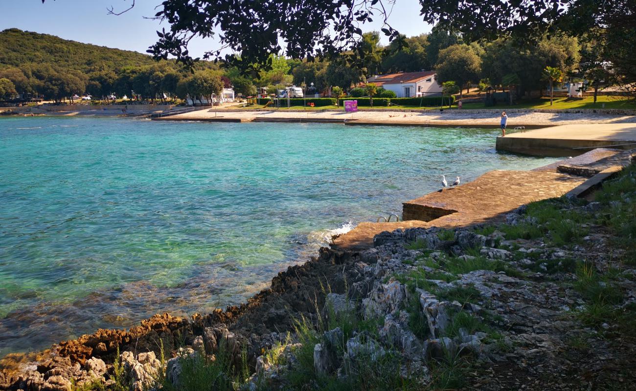 Porto Sole beach'in fotoğrafı beton kapak yüzey ile