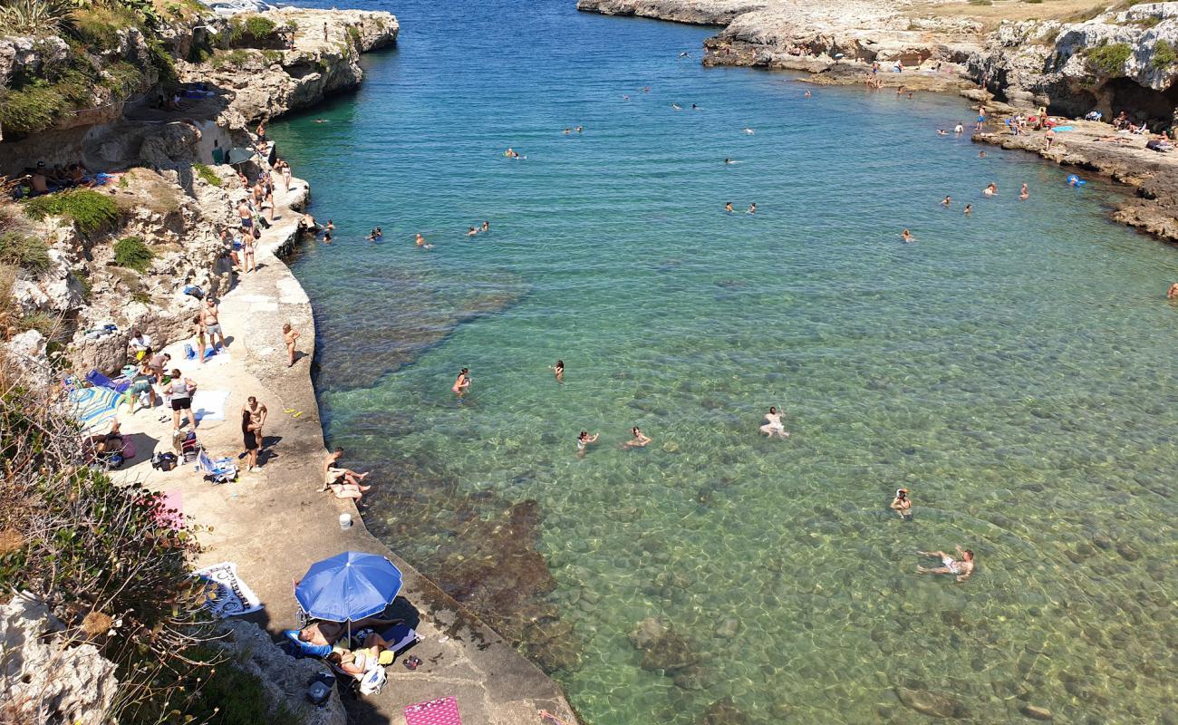 Cala Incine beach'in fotoğrafı parlak kum ve kayalar yüzey ile