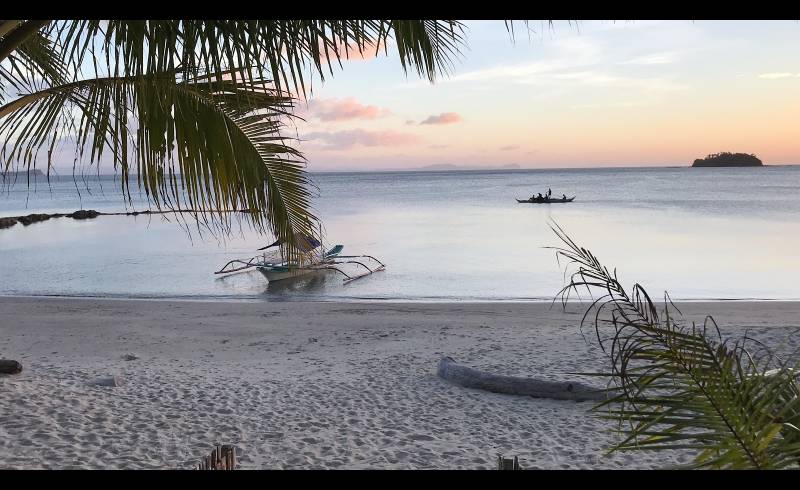 Lumambong Beach'in fotoğrafı parlak kum yüzey ile