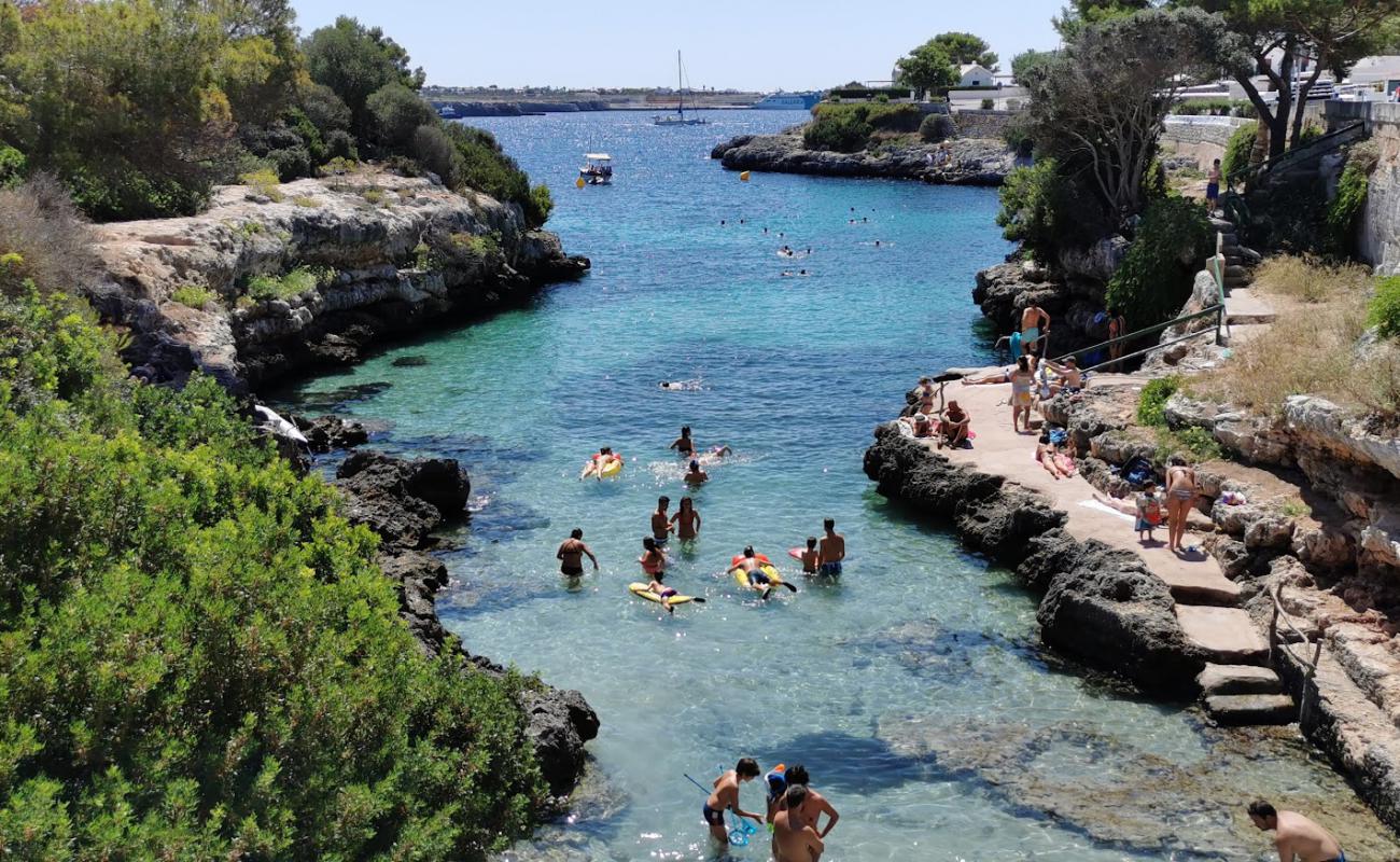 Platja de Sa Farola'in fotoğrafı parlak kum yüzey ile