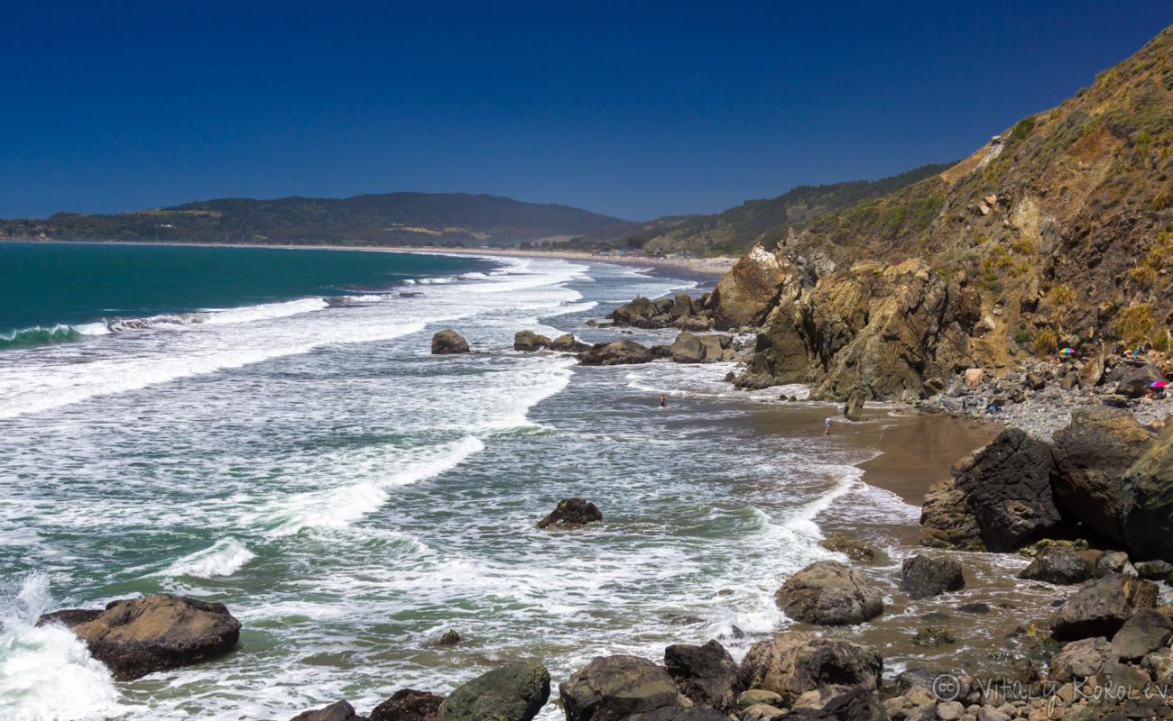 Red Rock Beach'in fotoğrafı parlak kum yüzey ile